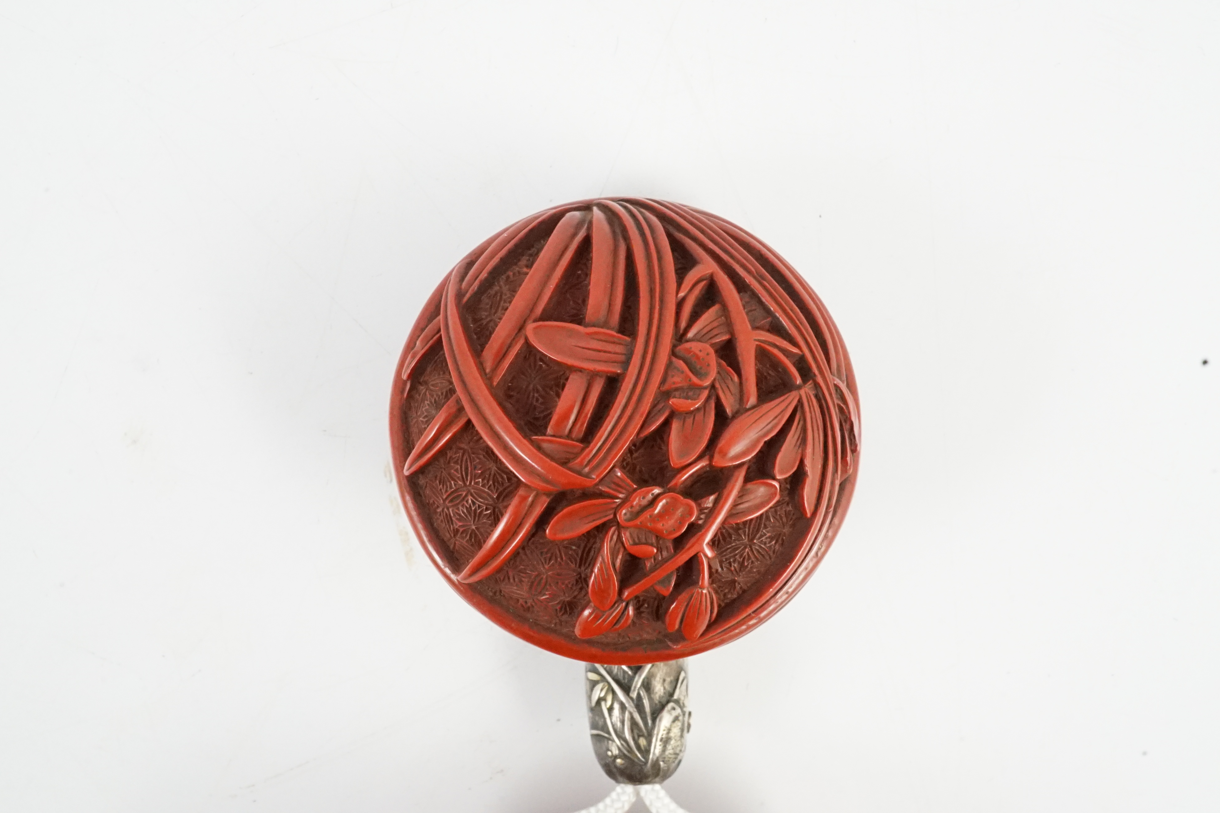 A good Japanese tsuishu (carved red lacquer) four case inro, by Yosei, and a similar manju netsuke, 19th century